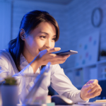 lady holding a mobile device on her right hand , living a massage