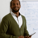 male teacher , holding a tablet device , white drawing chart