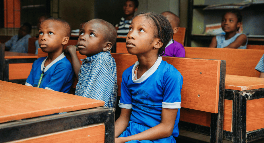 african kids sitting in the desk in the classroom 