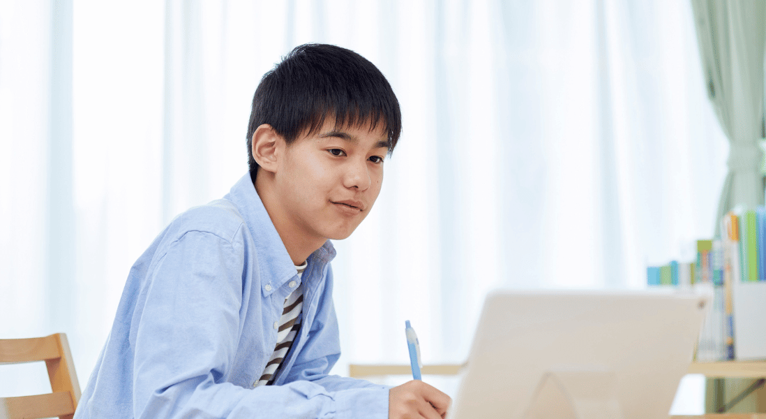 boy writing a online assessment for sa high school learners